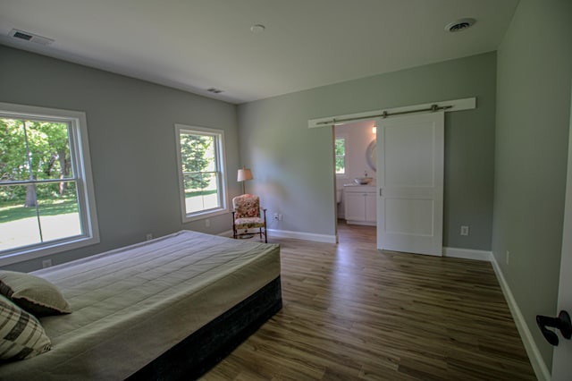 850 60th Ave SW, Benson, MN 56231 - bedroom with a barn door, multiple windows, dark wood finished floors, and baseboards