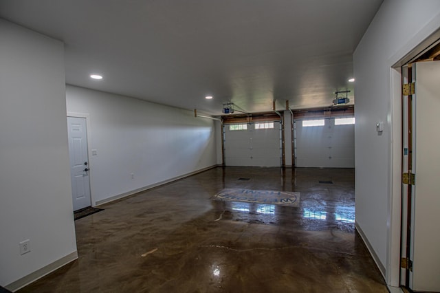 850 60th Ave SW, Benson, MN 56231 - garage featuring recessed lighting, a garage door opener, and baseboards
