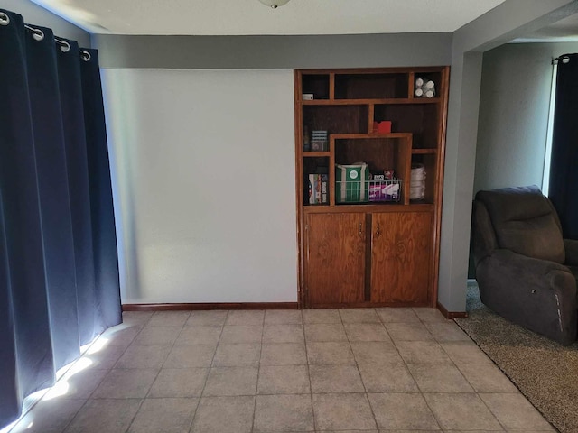 640 6th St, Albany, MN 56307 - living area with built in shelves, light tile patterned floors, and baseboards