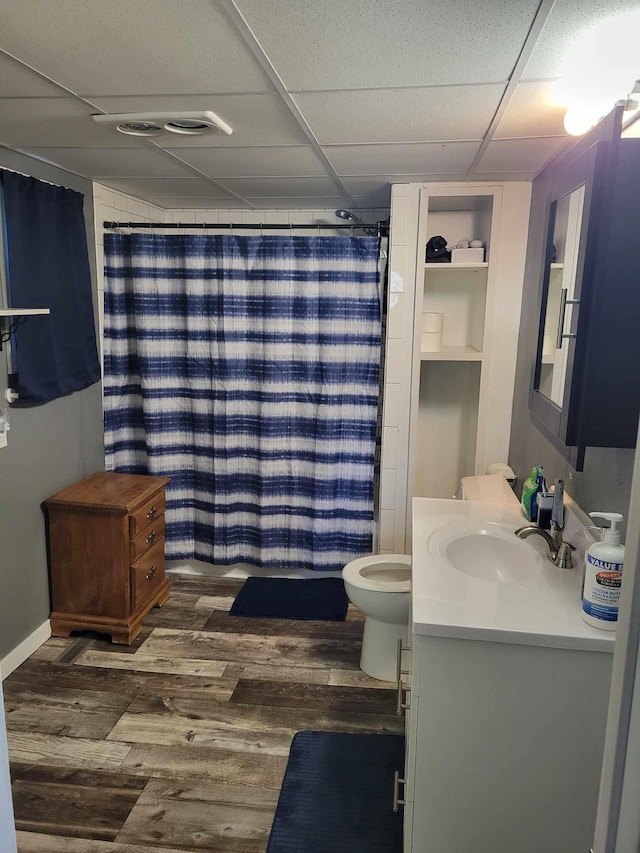 640 6th St, Albany, MN 56307 - full bath featuring vanity, wood finished floors, a drop ceiling, toilet, and curtained shower