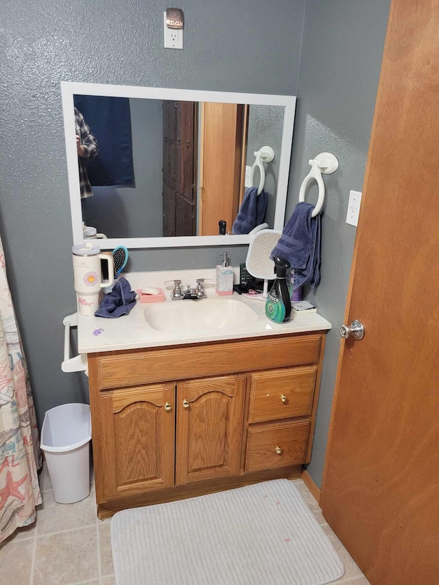 640 6th St, Albany, MN 56307 - bathroom with vanity, tile patterned floors, toilet, and a textured wall