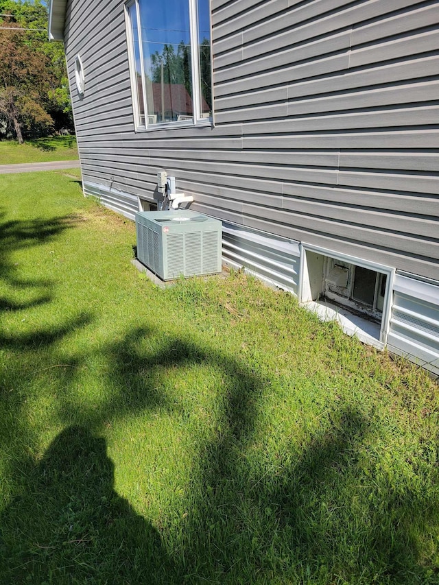 640 6th St, Albany, MN 56307 - view of side of home featuring central AC and a lawn