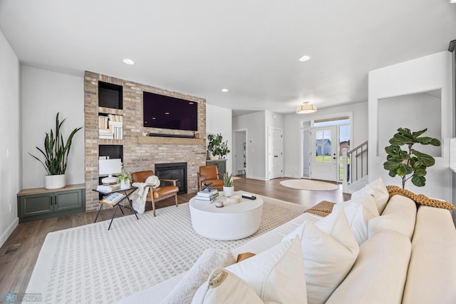 2652 70th Ave S, Fargo, ND 58104 - living room featuring dark wood finished floors, a fireplace, baseboards, stairway, and recessed lighting