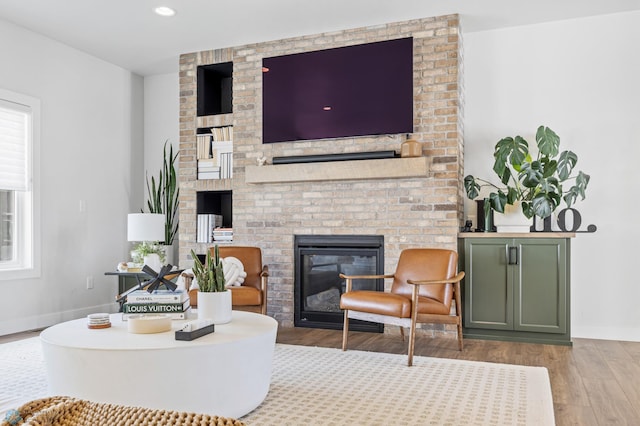 2652 70th Ave S, Fargo, ND 58104 - living area featuring wood finished floors, a brick fireplace, baseboards, and recessed lighting