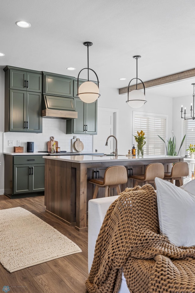 2652 70th Ave S, Fargo, ND 58104 - kitchen featuring backsplash, custom exhaust hood, a sink, dark wood-style flooring, and a kitchen bar