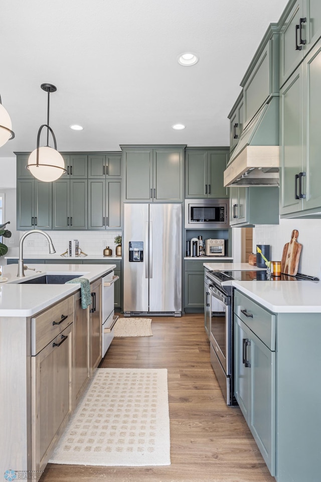 2652 70th Ave S, Fargo, ND 58104 - kitchen featuring stainless steel appliances, recessed lighting, light countertops, tasteful backsplash, and decorative light fixtures