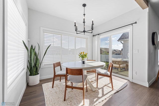 2652 70th Ave S, Fargo, ND 58104 - dining area with baseboards, dark wood finished floors, and a chandelier