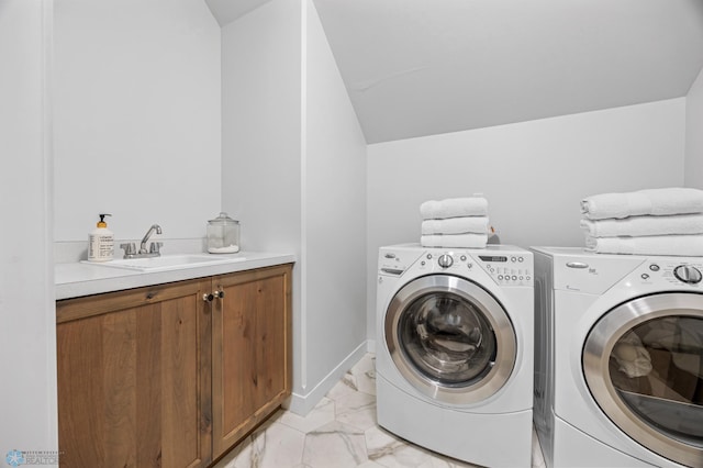 2652 70th Ave S, Fargo, ND 58104 - washroom with light marble finish flooring, washing machine and clothes dryer, and cabinet space