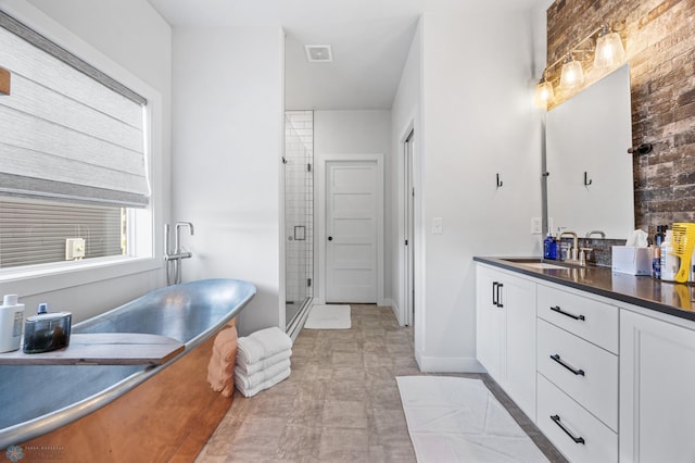 2652 70th Ave S, Fargo, ND 58104 - full bathroom featuring vanity, a freestanding tub, a shower stall, and tile patterned floors