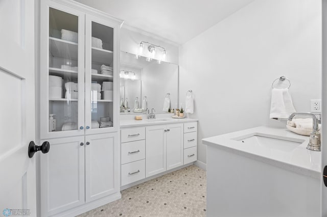 2652 70th Ave S, Fargo, ND 58104 - bathroom with double vanity, tile patterned floors, and baseboards