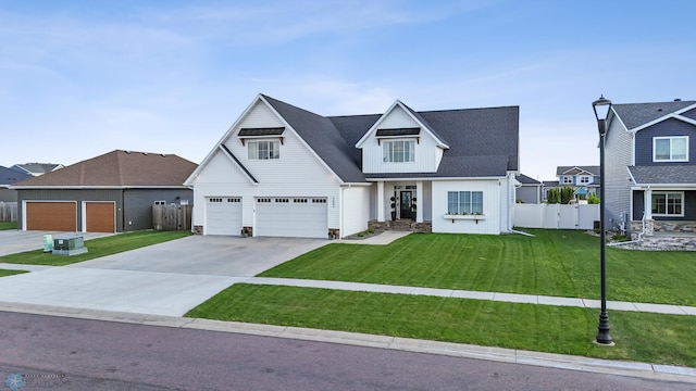 2652 70th Ave S, Fargo, ND 58104 - view of front of home featuring concrete driveway, an attached garage, stone siding, and board and batten siding