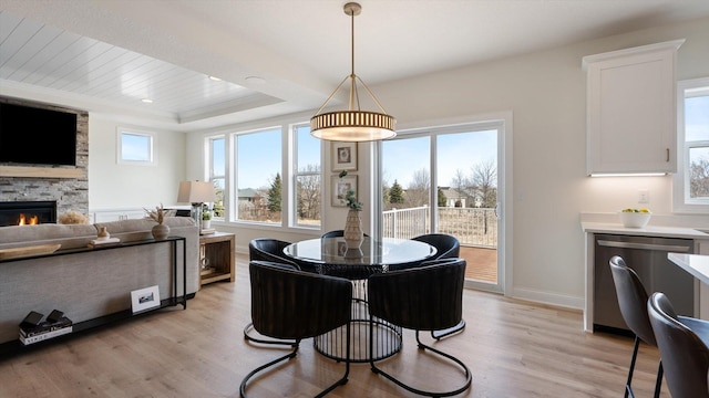 1949 Lusitano St, Shakopee, MN 55379 - dining room featuring light wood-type flooring, a fireplace, and baseboards
