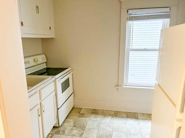 310 Burgess St, Saint Paul, MN 55117 - kitchen featuring electric stove, white cabinetry, and light countertops