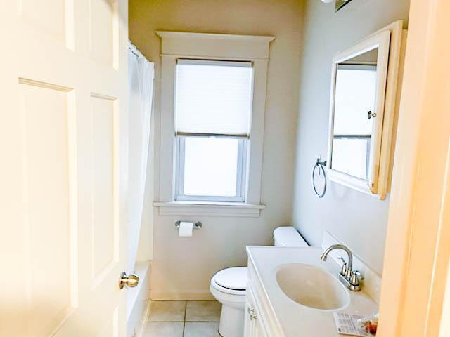 310 Burgess St, Saint Paul, MN 55117 - bathroom with toilet, tile patterned floors, and vanity
