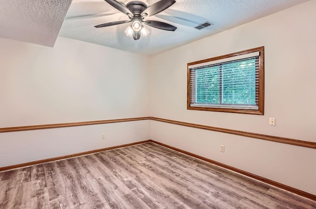 4900 Hodgson Rd, Connection, Shoreview, MN 55126 - unfurnished room featuring a textured ceiling, wood finished floors, and ceiling fan