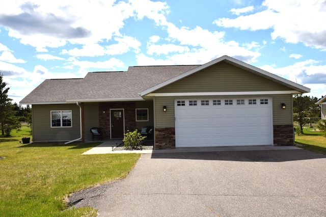2008 Whiting Rd NW Unit 10, Bemidji, MN 56601 - view of front of home featuring asphalt driveway, stone siding, a front yard, and a garage