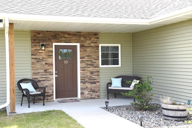 2008 Whiting Rd NW Unit 10, Bemidji, MN 56601 - property entrance featuring a shingled roof and a porch