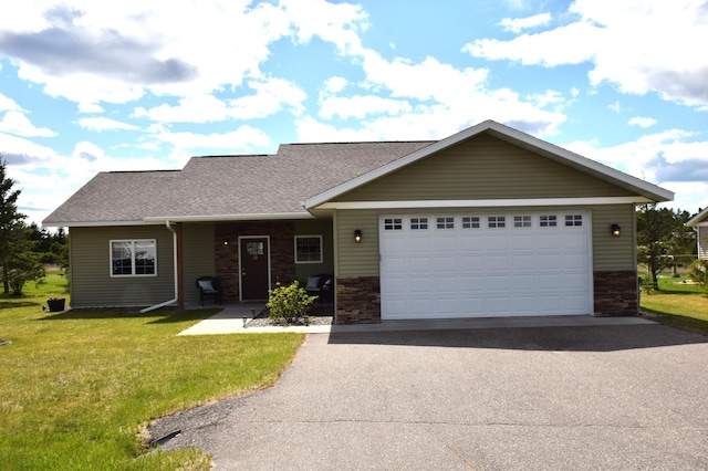 2008 Whiting Rd NW Unit 10, Bemidji, MN 56601 - view of front of property with driveway, stone siding, a front yard, and a garage