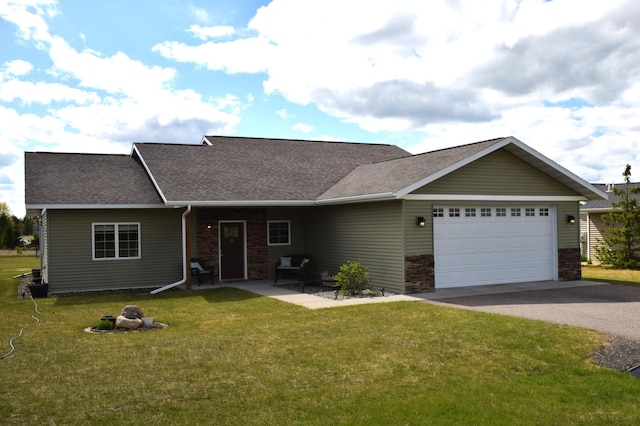 2008 Whiting Rd NW Unit 10, Bemidji, MN 56601 - view of front of house featuring driveway, an attached garage, a front yard, a shingled roof, and stone siding