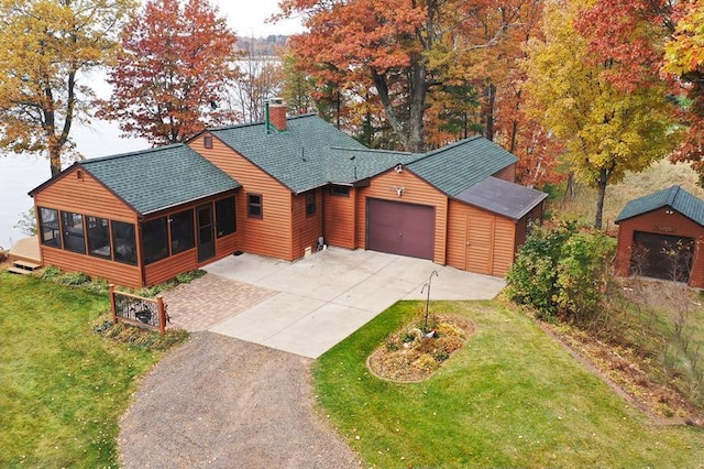 29626 436th Pl, Farm Island Twp, MN 56431 - rustic home featuring driveway, a shingled roof, a sunroom, a chimney, and an attached garage