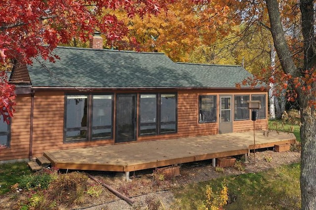 29626 436th Pl, Farm Island Twp, MN 56431 - rear view of house featuring a chimney, roof with shingles, and a wooden deck