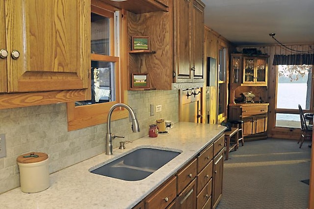 29626 436th Pl, Farm Island Twp, MN 56431 - kitchen with a sink, glass insert cabinets, decorative backsplash, and light stone counters