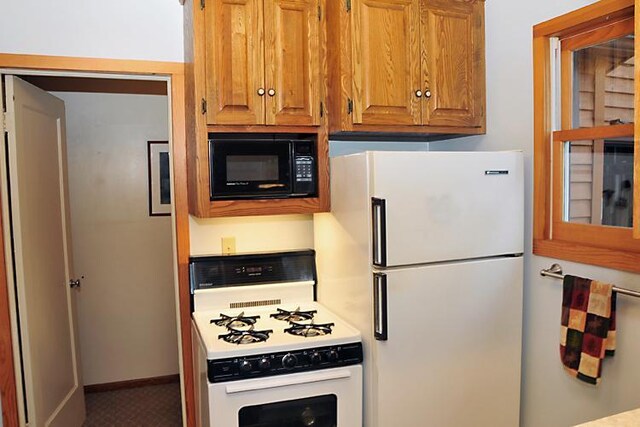29626 436th Pl, Farm Island Twp, MN 56431 - kitchen with white appliances, brown cabinets, and light countertops