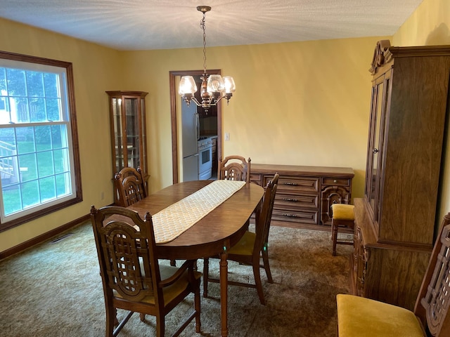 7765 Woodpark Blvd, Woodbury, MN 55125 - dining room with dark colored carpet and a chandelier