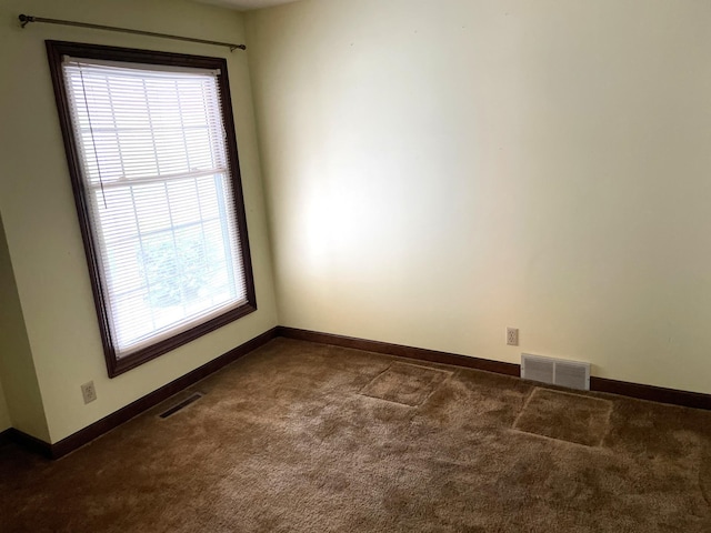 7765 Woodpark Blvd, Woodbury, MN 55125 - empty room with dark carpet and baseboards