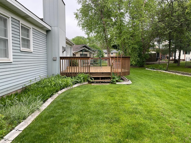 7765 Woodpark Blvd, Woodbury, MN 55125 - view of grassy yard featuring a wooden deck