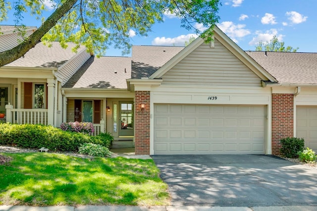 1439 Summit Shores Dr, Burnsville, MN 55306 - view of front facade featuring a garage, brick siding, and driveway