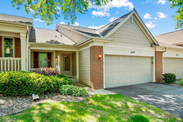1439 Summit Shores Dr, Burnsville, MN 55306 - ranch-style house with an attached garage, brick siding, asphalt driveway, and roof with shingles