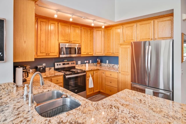 1439 Summit Shores Dr, Burnsville, MN 55306 - kitchen with stainless steel appliances, a sink, light stone counters, and track lighting
