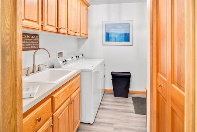 1439 Summit Shores Dr, Burnsville, MN 55306 - laundry room with cabinet space, separate washer and dryer, light wood finished floors, and baseboards