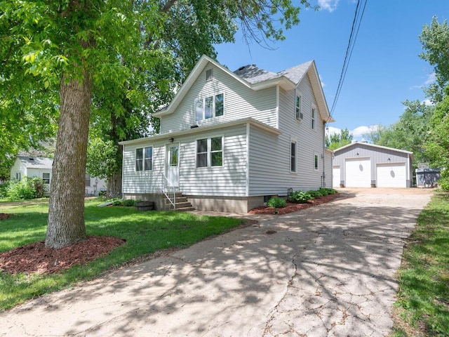 306 Benton St W, Cologne, MN 55322 - traditional-style home with entry steps, an outbuilding, a detached garage, and a front lawn