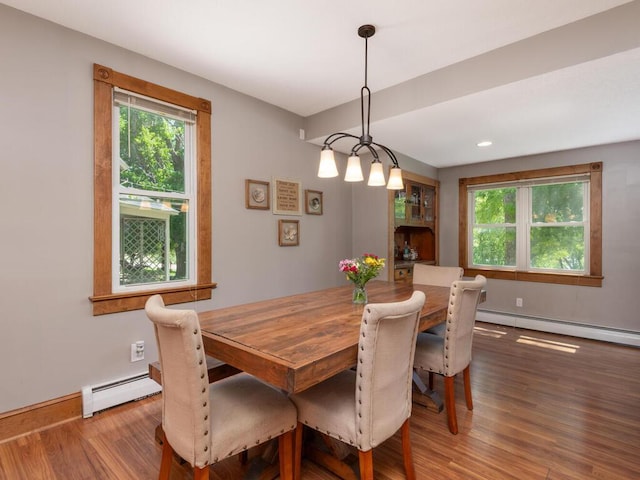 306 Benton St W, Cologne, MN 55322 - dining area with baseboard heating, wood finished floors, and baseboards