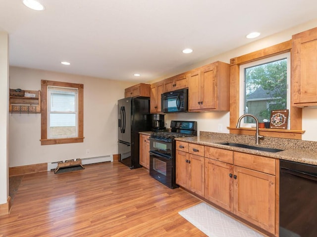 306 Benton St W, Cologne, MN 55322 - kitchen with black appliances, a sink, light wood-type flooring, light stone countertops, and recessed lighting