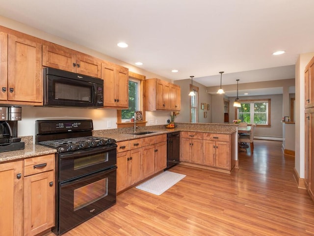 306 Benton St W, Cologne, MN 55322 - kitchen featuring black appliances, a peninsula, light wood-style floors, a baseboard radiator, and a sink