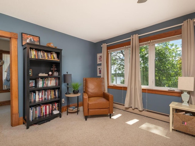 306 Benton St W, Cologne, MN 55322 - living area featuring a baseboard heating unit, carpet flooring, and baseboards