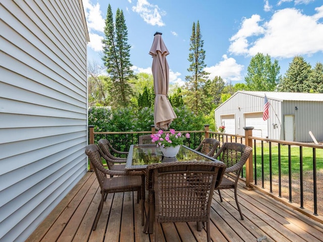 306 Benton St W, Cologne, MN 55322 - deck with outdoor dining area, a garage, and an outbuilding