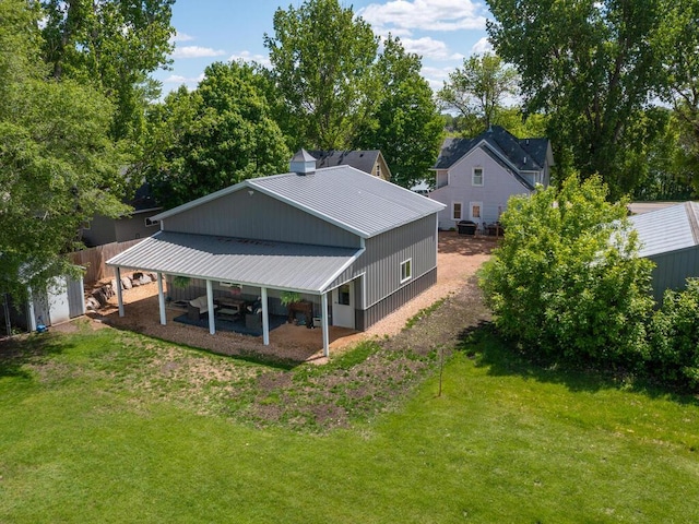 306 Benton St W, Cologne, MN 55322 - back of property featuring a lawn, metal roof, and an outbuilding