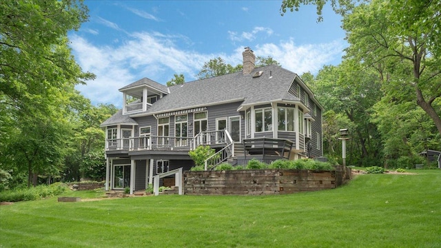 7420 Long Lake Rd, Dovre Twp, MN 56201 - rear view of house featuring a wooden deck, a sunroom, a yard, a chimney, and roof with shingles
