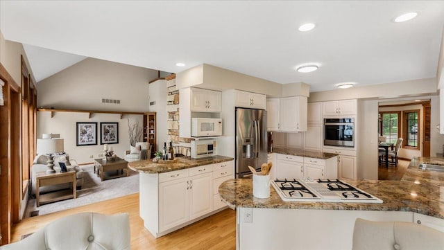 7420 Long Lake Rd, Dovre Twp, MN 56201 - kitchen featuring appliances with stainless steel finishes, light wood-type flooring, a peninsula, stone countertops, and white cabinets