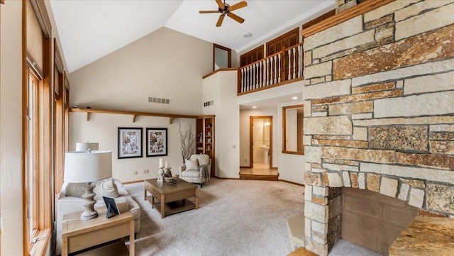 7420 Long Lake Rd, Dovre Twp, MN 56201 - carpeted living room featuring a ceiling fan, baseboards, high vaulted ceiling, and a stone fireplace