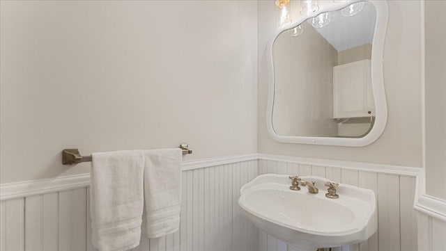 7420 Long Lake Rd, Dovre Twp, MN 56201 - bathroom featuring wainscoting, a sink, and a decorative wall