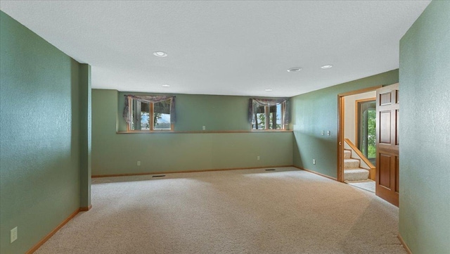 7420 Long Lake Rd, Dovre Twp, MN 56201 - carpeted spare room featuring healthy amount of natural light, baseboards, recessed lighting, and stairs