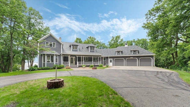 7420 Long Lake Rd, Dovre Twp, MN 56201 - view of front of house with driveway, covered porch, an attached garage, a chimney, and a front lawn