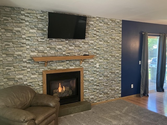 408 Beech Ave, Fergus Falls, MN 56537 - living area featuring baseboards, a glass covered fireplace, and wood finished floors
