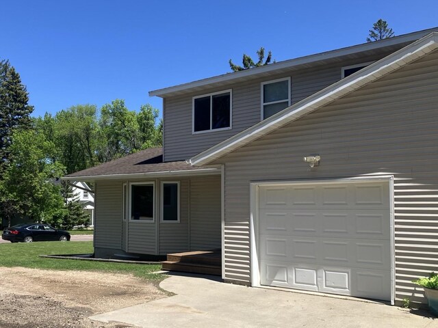 408 Beech Ave, Fergus Falls, MN 56537 - view of front of property with a garage, a shingled roof, and driveway