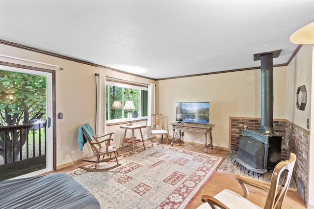 8847 Ironwood Ave S, Cottage Grove, MN 55016 - living area featuring a wood stove, wood finished floors, and ornamental molding